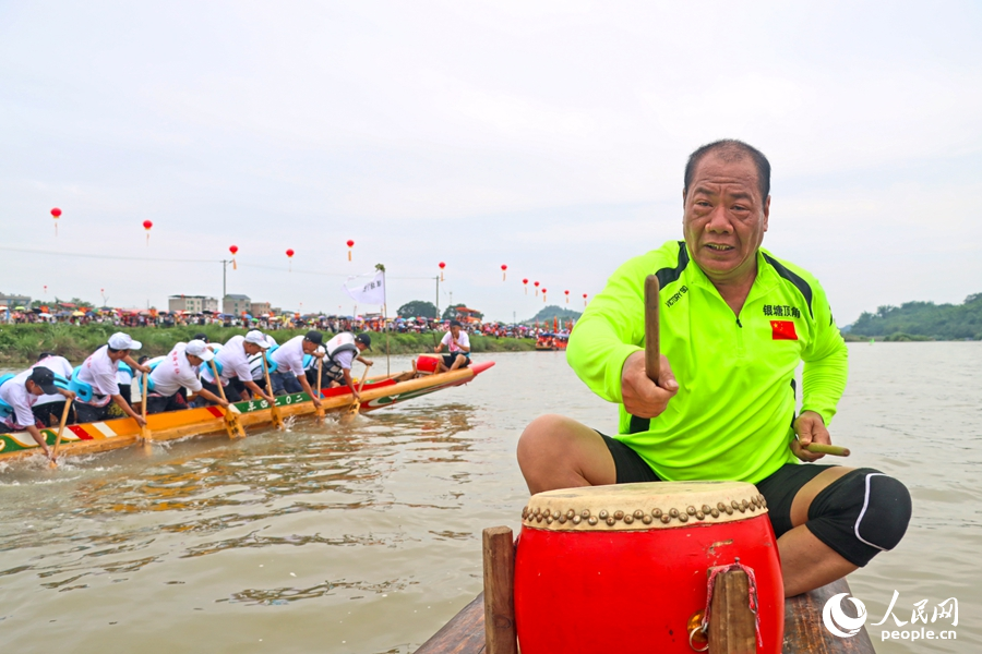 鼓手敲鑼，激勵(lì)隊(duì)員們齊心協(xié)力劃槳。人民網(wǎng) 李昌乾攝