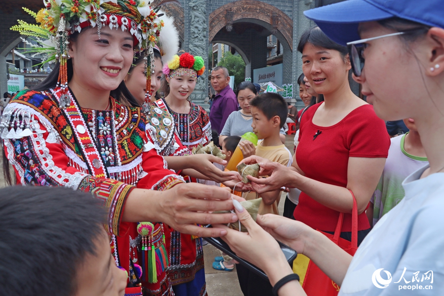 為游客免費(fèi)派發(fā)“烏米粽”。人民網(wǎng) 李昌乾攝